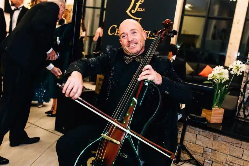 Cellist performing at event, featured in vendor listing card.