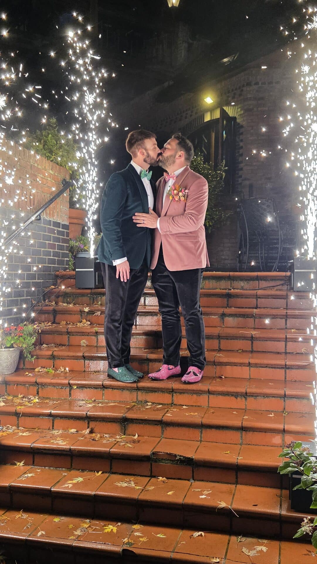 Two grooms outdoors at the rabbit hotel in northern ireland, sharing a kiss with fountains of cold sparks, by EVENTS BY Cassidy McCleans