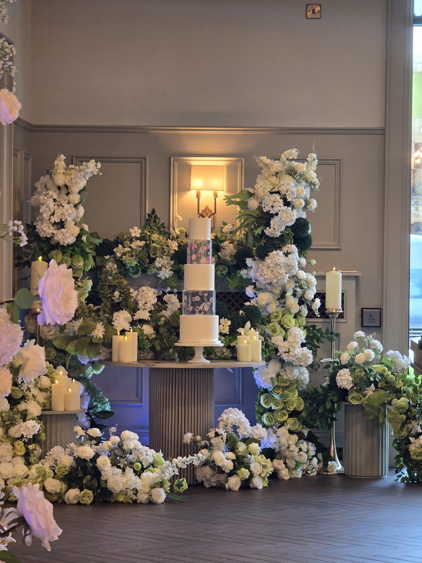 If your cake is a simple design, add a gorgeous floral display to surround it! wedding cake display