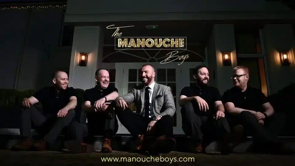 Band members seated outside venue with “Manouche Boys” sign, featured in vendor listing card.