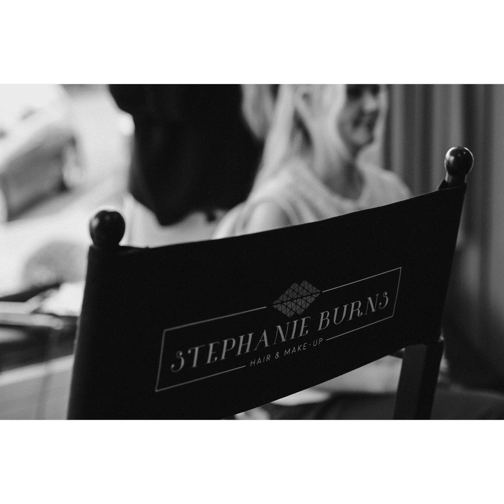 Black and white image of a chair with "Stephanie Burns Hair & Make-Up" printed on the back.