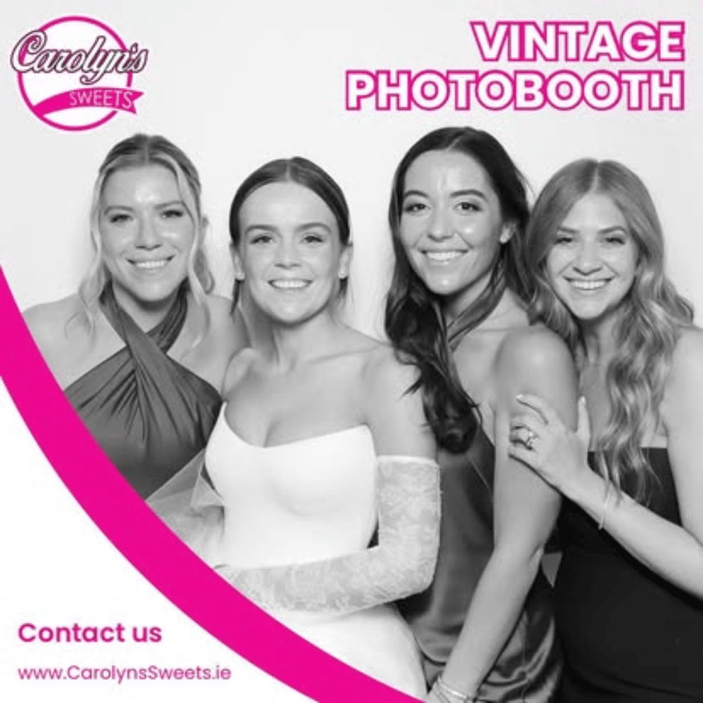 Four women posing in a vintage photobooth, smiling. Branding for Carolyn's Sweets visible.