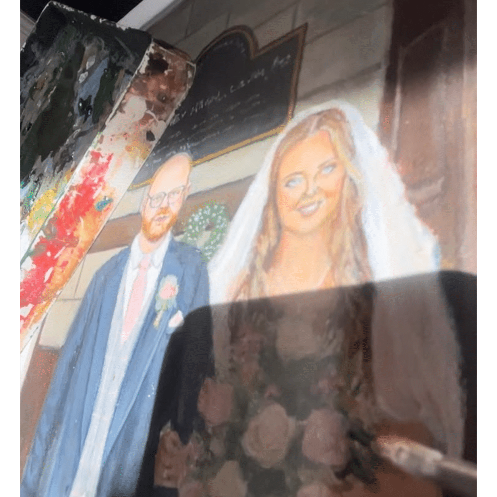 Painting of a bride and groom next to an artist's palette and paintbrush.