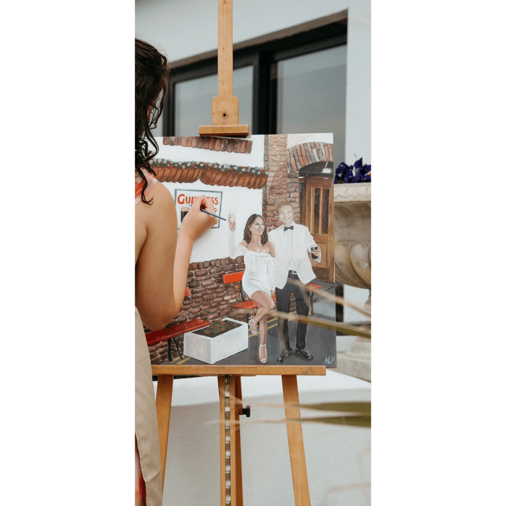 Artist painting a couple on a canvas set on an easel.