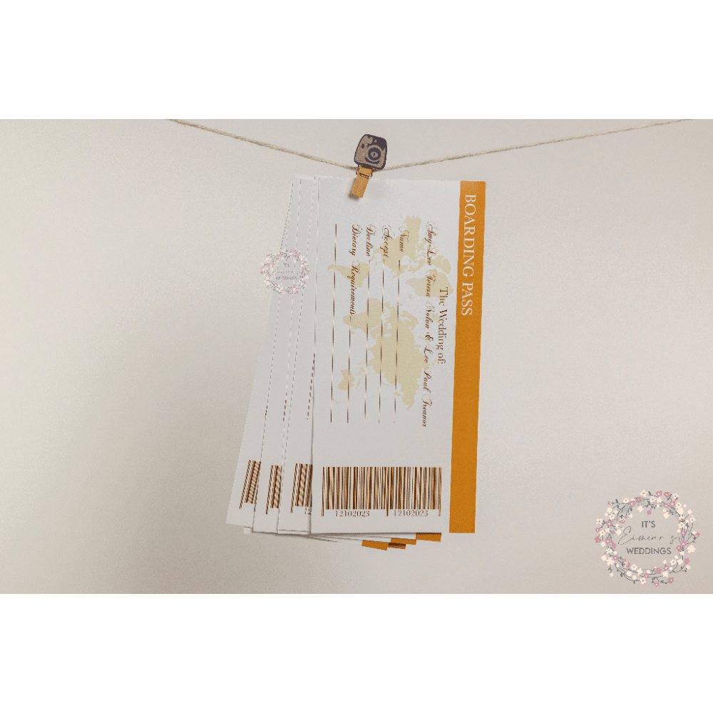Wedding-themed boarding pass invitations hanging on a string with a clothespin.