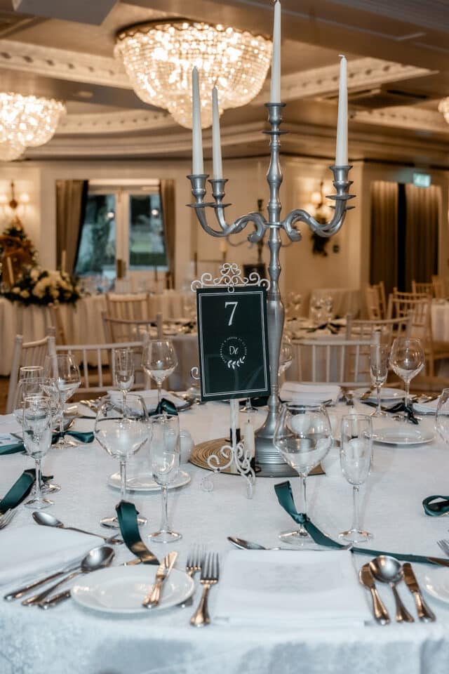 Elegant wedding table setting at Bellingham Castle with candelabra and table number 7.