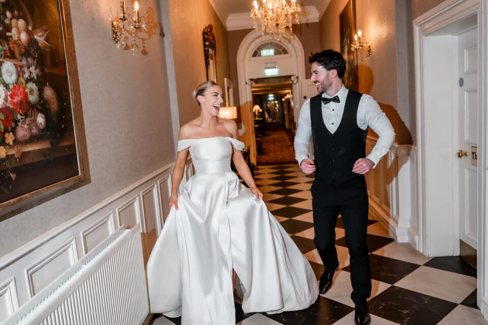 Bride and Groom running through the elegant hallways of Bellingham Castle.