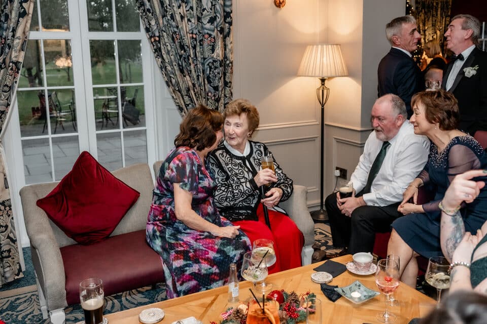Guests socializing in a cozy room at Bellingham Castle.