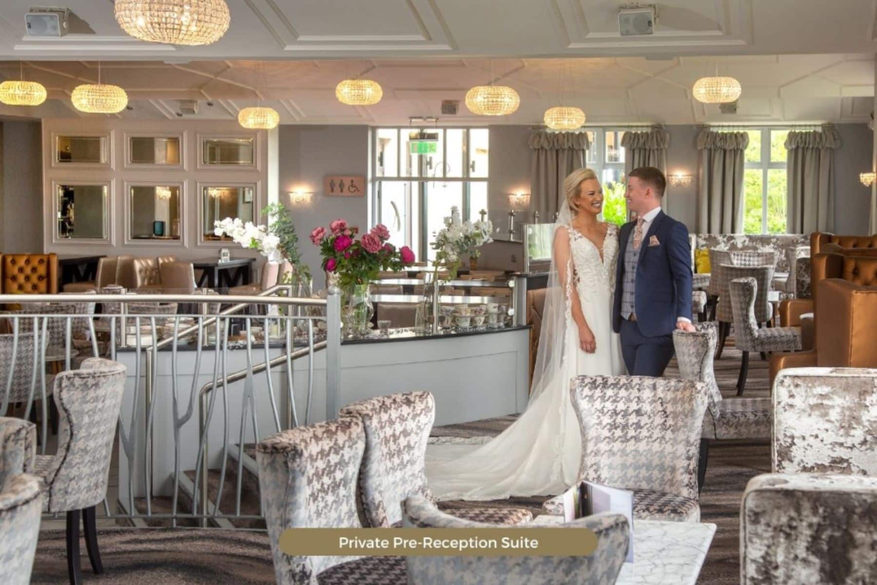 Bride and groom in elegant pre-reception suite at Four Seasons Hotel Monaghan, surrounded by plush seating and floral decor.