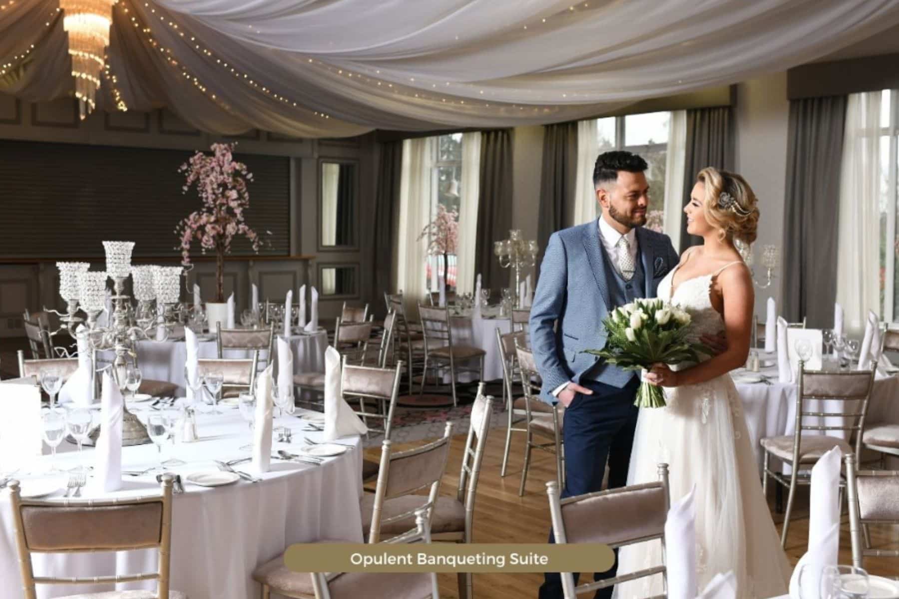 Bride and groom in elegant, decorated banquet hall with draped ceiling at Four Seasons Hotel Monaghan.