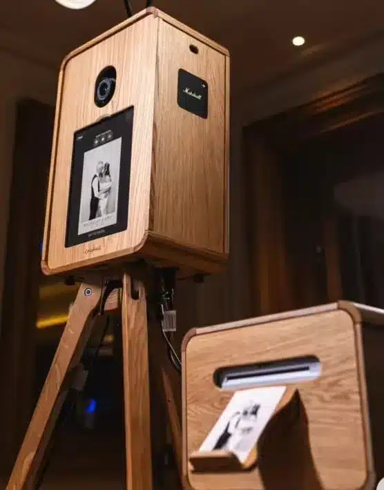 Wooden photo booth setup with camera and controls, featured in vendor listing card.