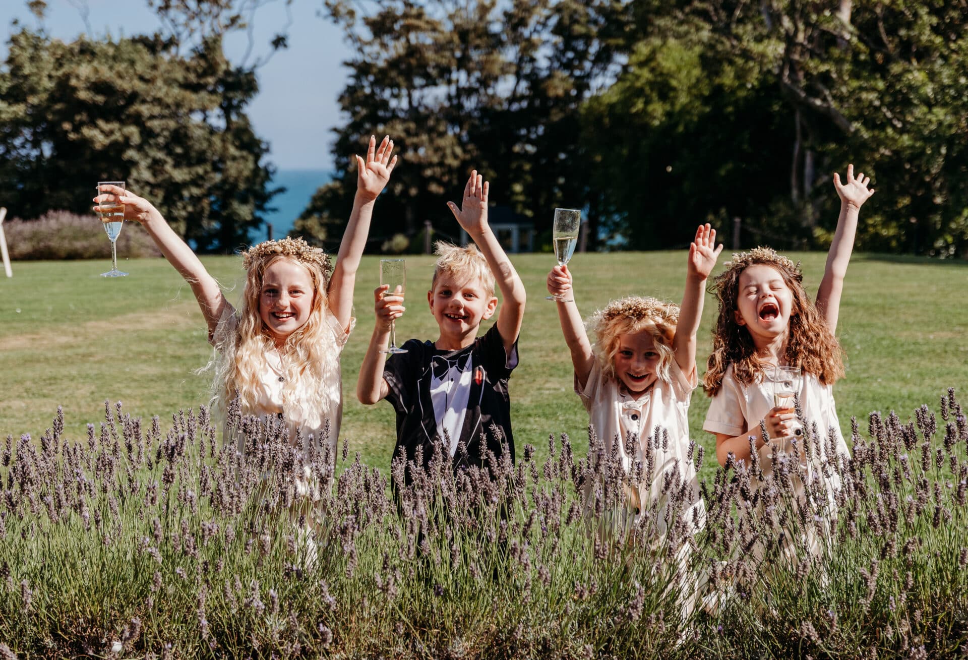 Children celebrating and playing outdoors at a wedding reception in Northern Ireland with dedicated wedding childcare
