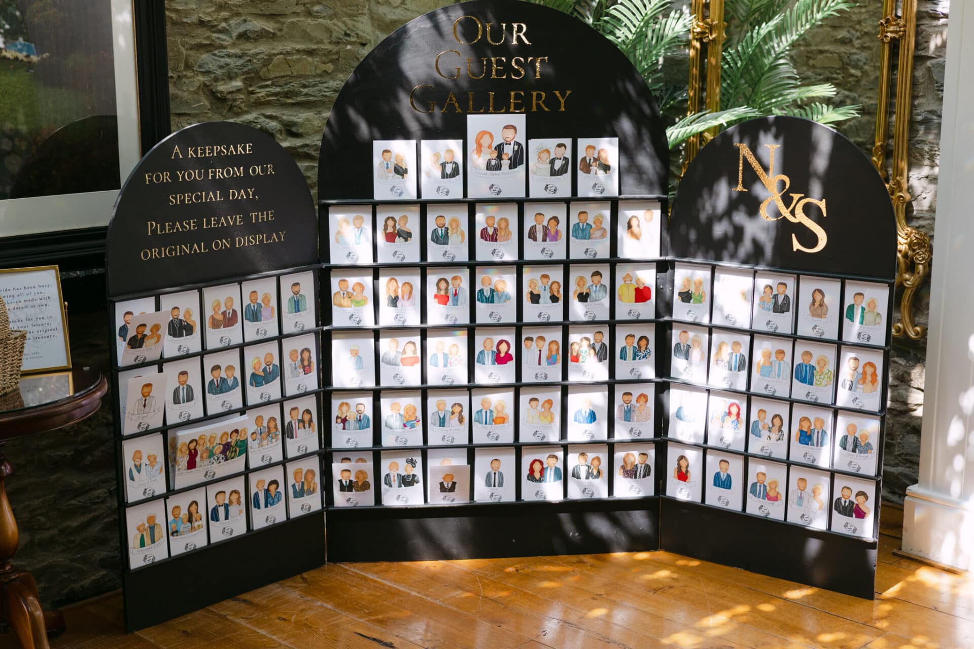 Display of hand-drawn wedding guest portraits created by the bride at Darver Castle, with individual illustrated keepsakes arranged for guests to collect on arrival.