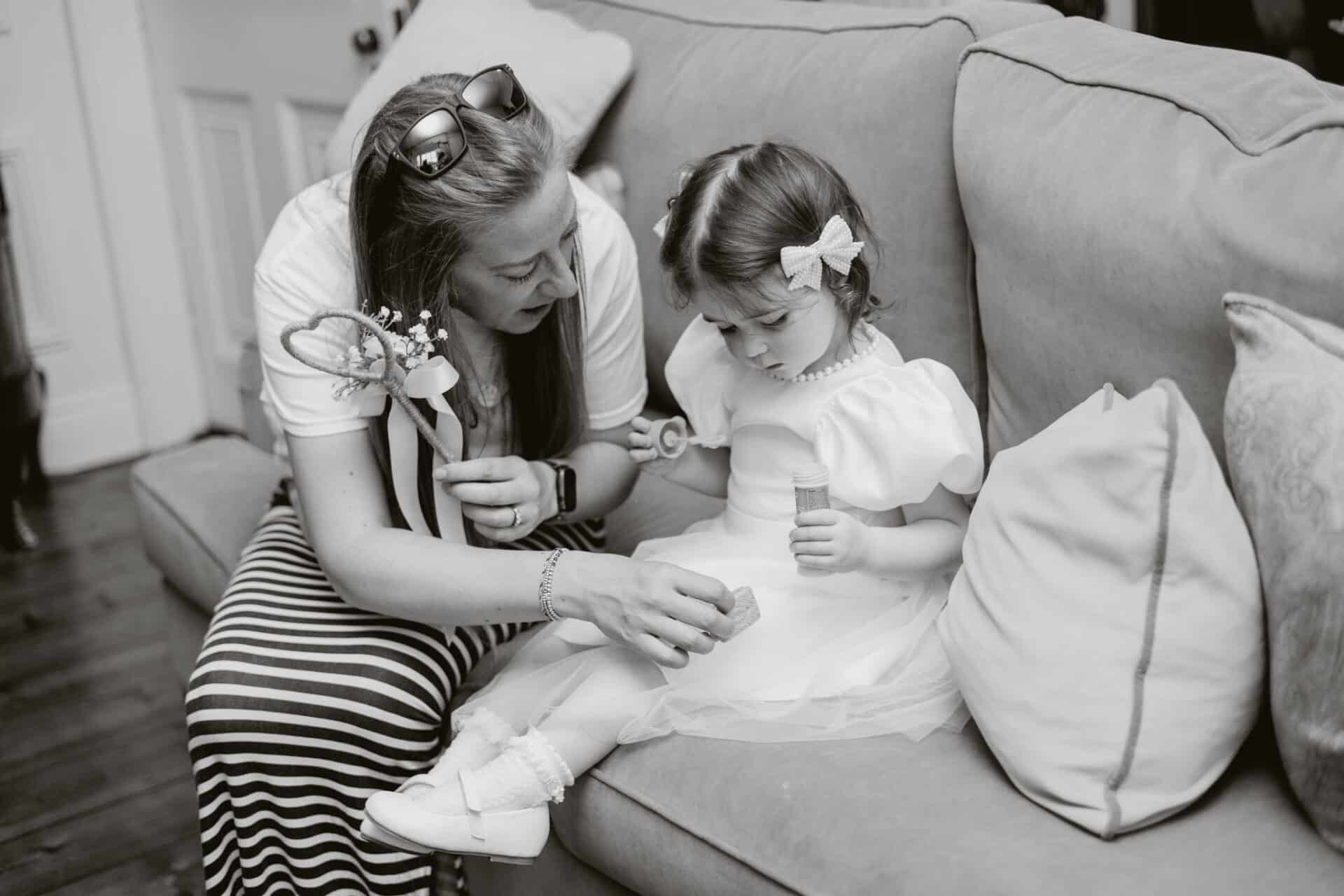 A quiet moment between Nanny Cat and Natalie and Stephen’s youngest daughter as they sit together indoors during the drinks reception at Darver Castle