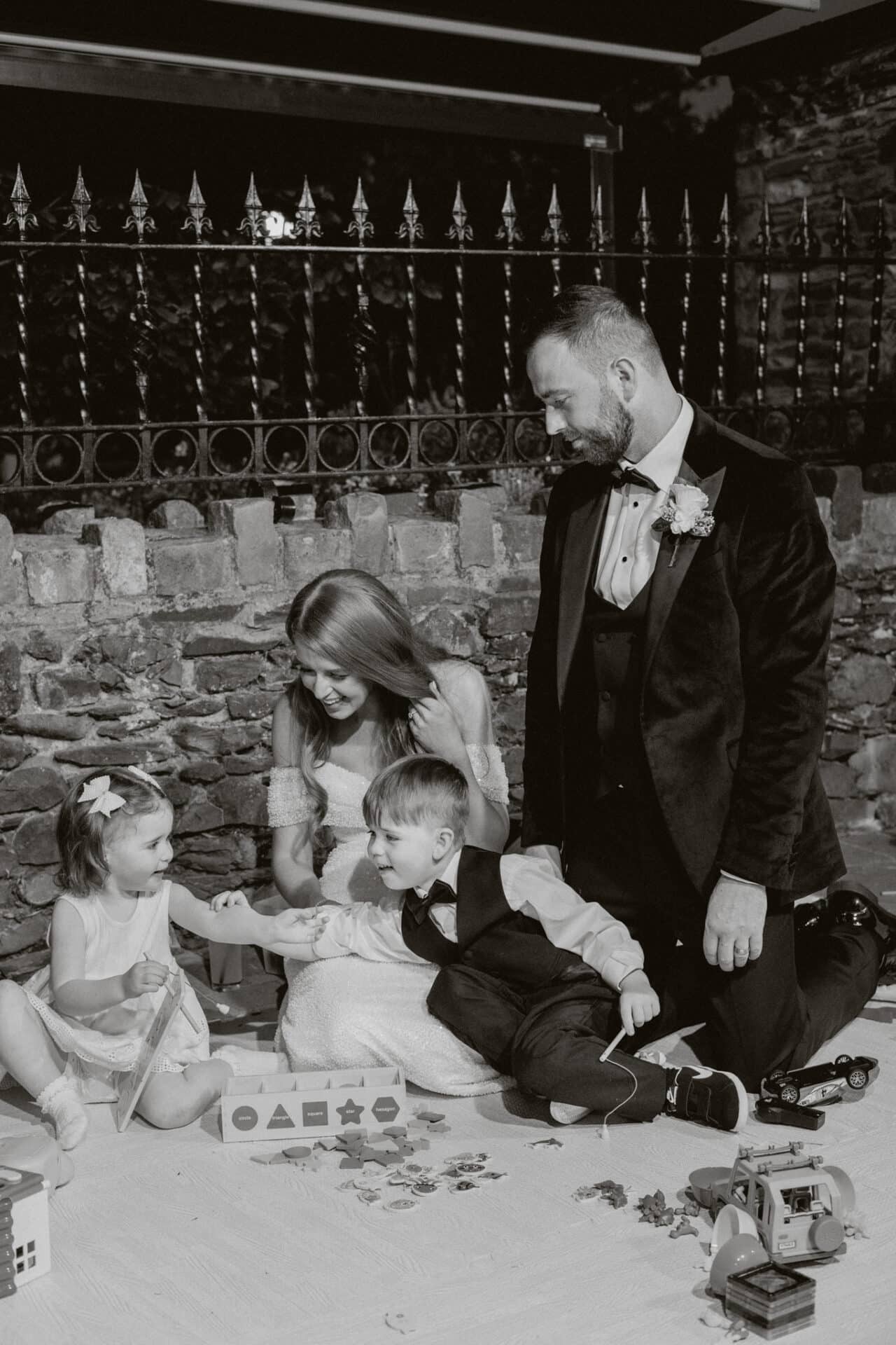 The bride and groom spend time playing with their children in Nanny Cats special play area during the evening reception, creating special family moments on their wedding day