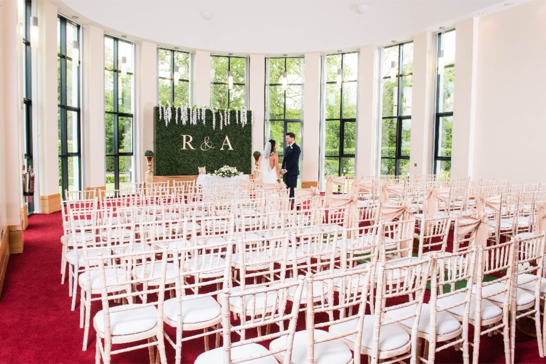 Wedding ceremony setup at La Mon Hotel & Country Club with decorative initials R & A.