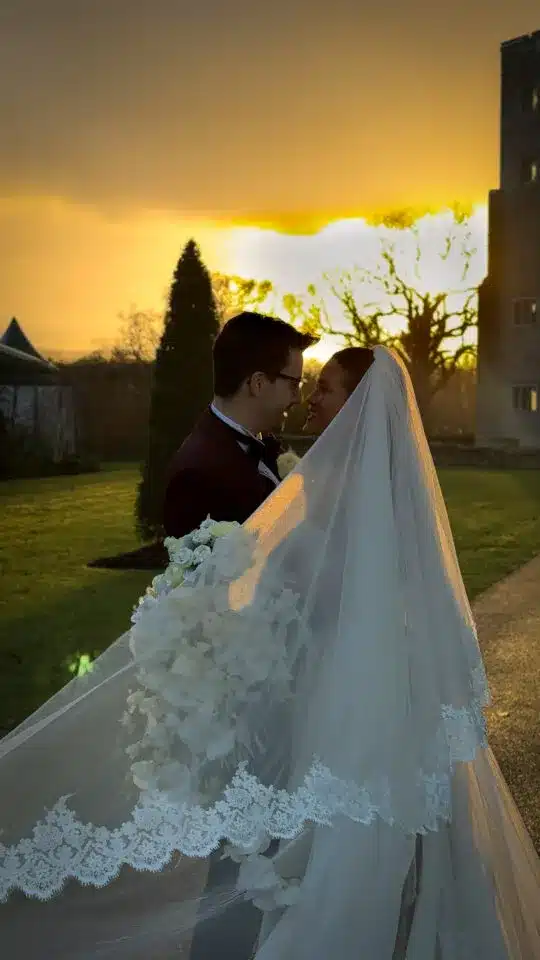 Bride and groom embracing at sunset outdoors, featured in vendor listing card.
