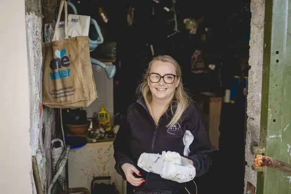 Woman holding wedding accessories in workshop, featured in vendor listing card.