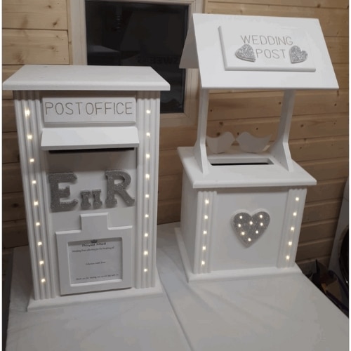 White wedding post box and post office box decorated with LED lights and heart designs.