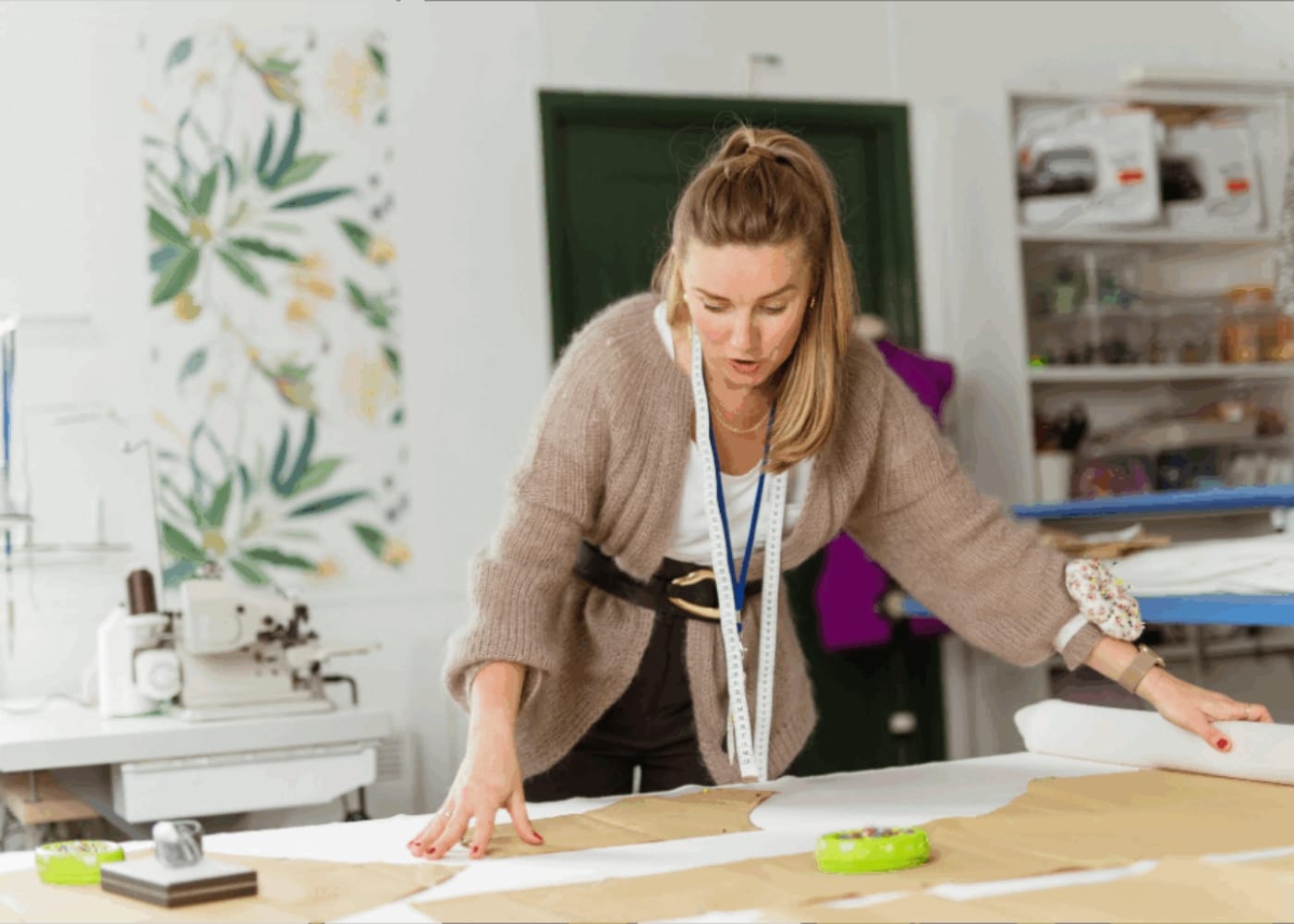 Designer working on sewing patterns in a fashion studio.