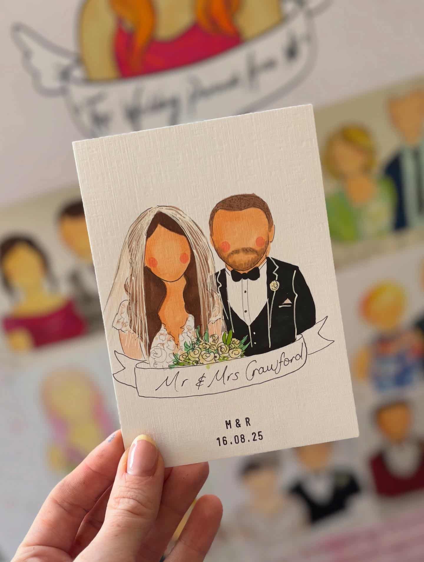 Hand holding a custom illustrated wedding card featuring a bride and groom, with the date 16.08.25 displayed.