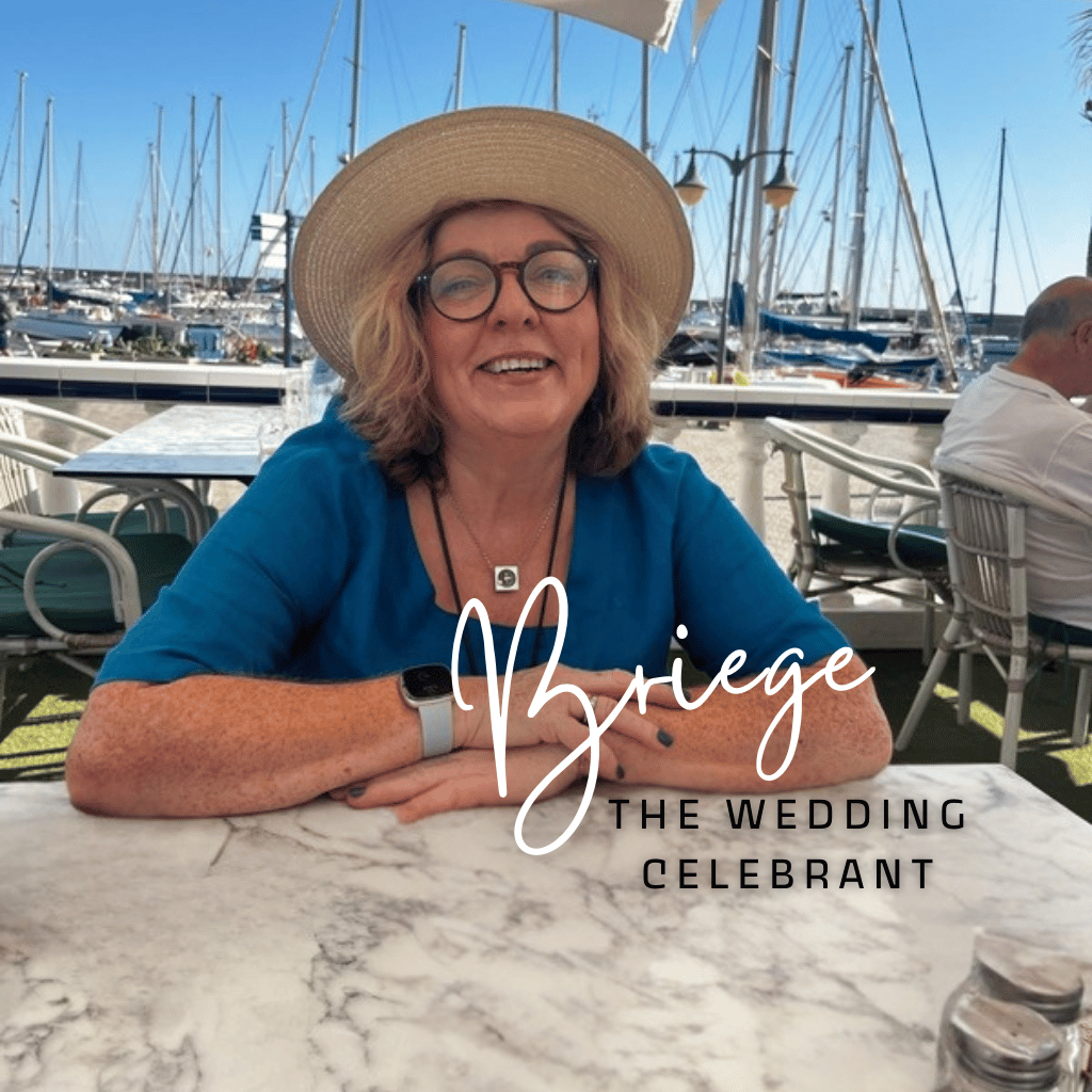 Woman in a hat sitting at an outdoor cafe by a marina with sailboats in the background. Text overlay reads "Briege The Wedding Celebrant."