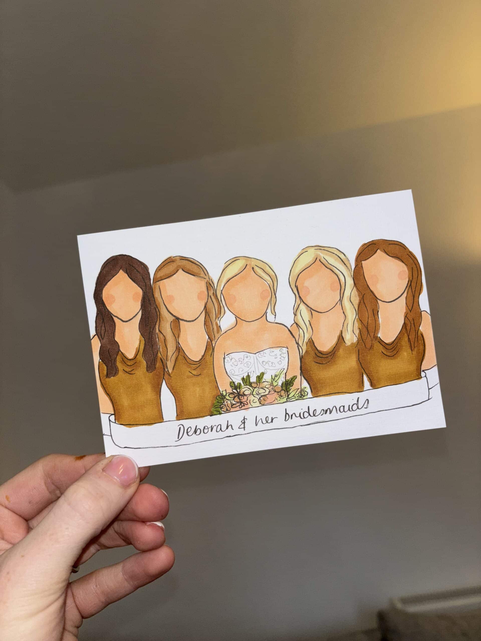 Illustrated card of a bride with four bridesmaids in brown dresses, held by a hand.
