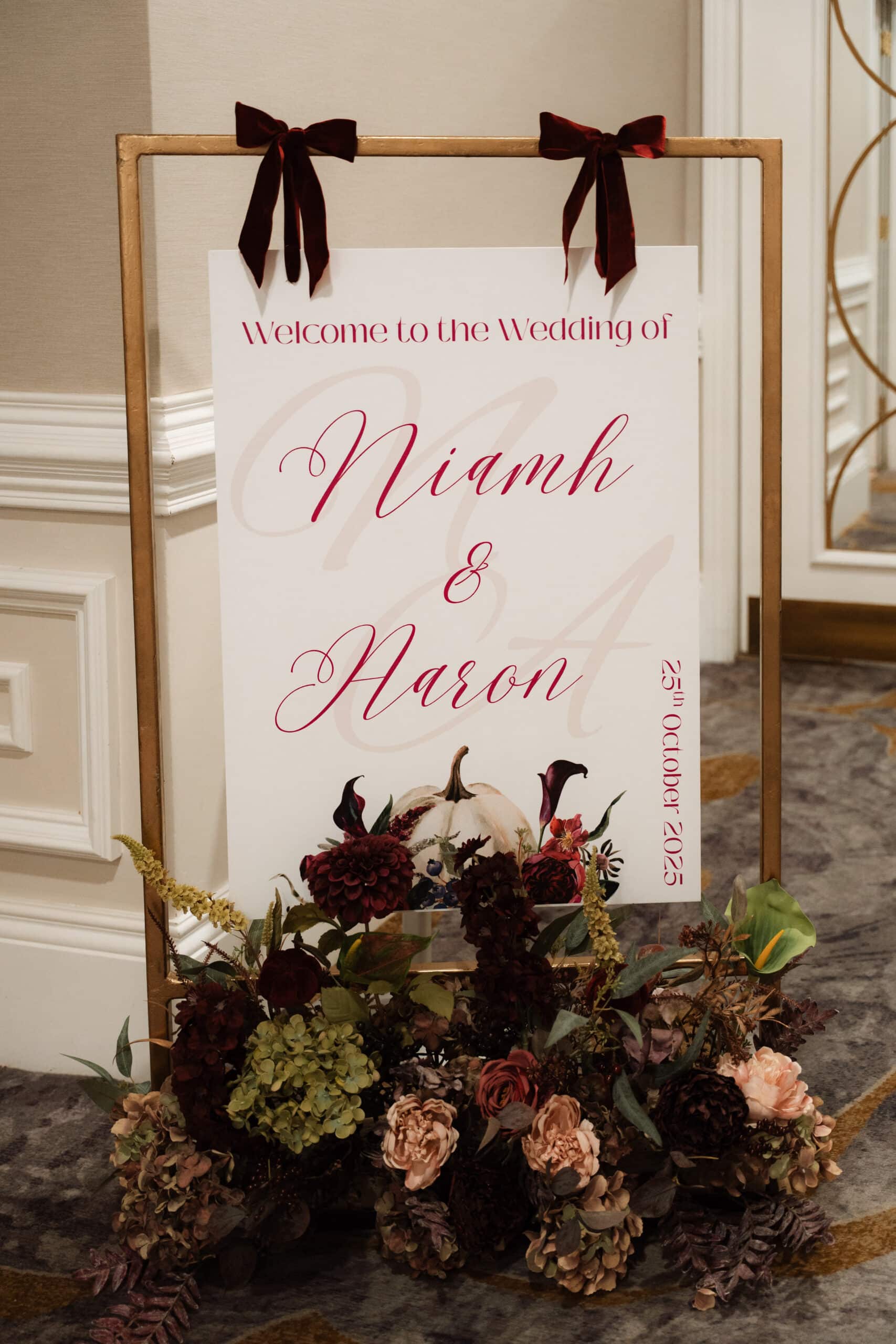 Wedding welcome sign for Niamh and Aaron with floral decor, dated 25th October 2025.