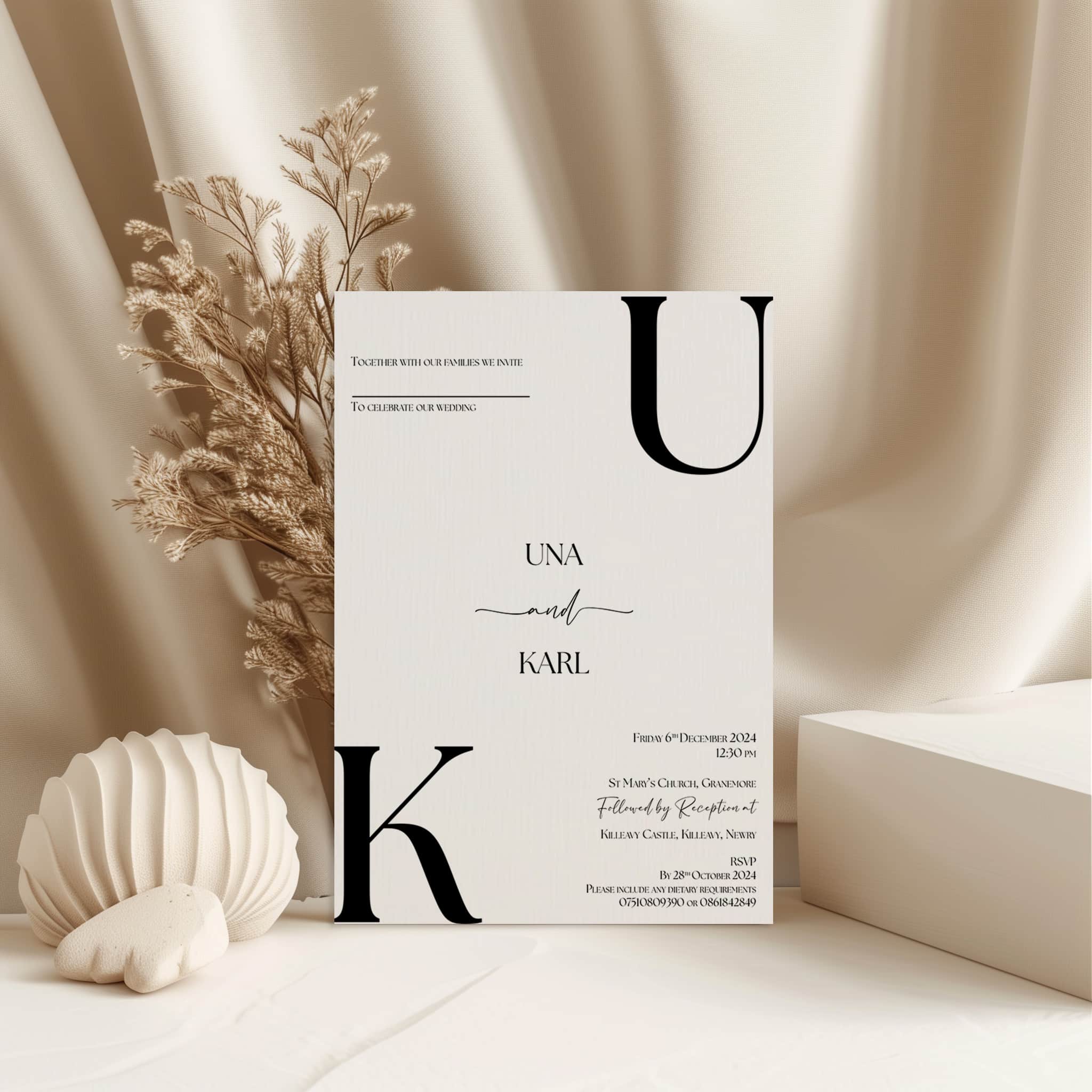 Minimal wedding invitation design with delicate plant decor and a shell element on a soft beige background.