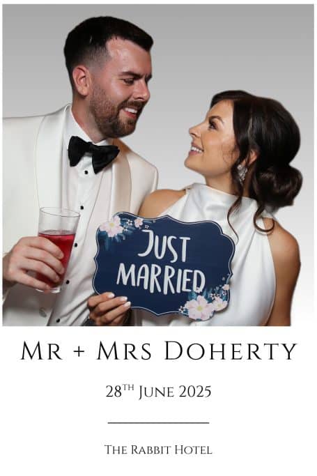Newlyweds smiling, holding a "Just Married" sign, dated 28th June 2025, at The Rabbit Hotel.