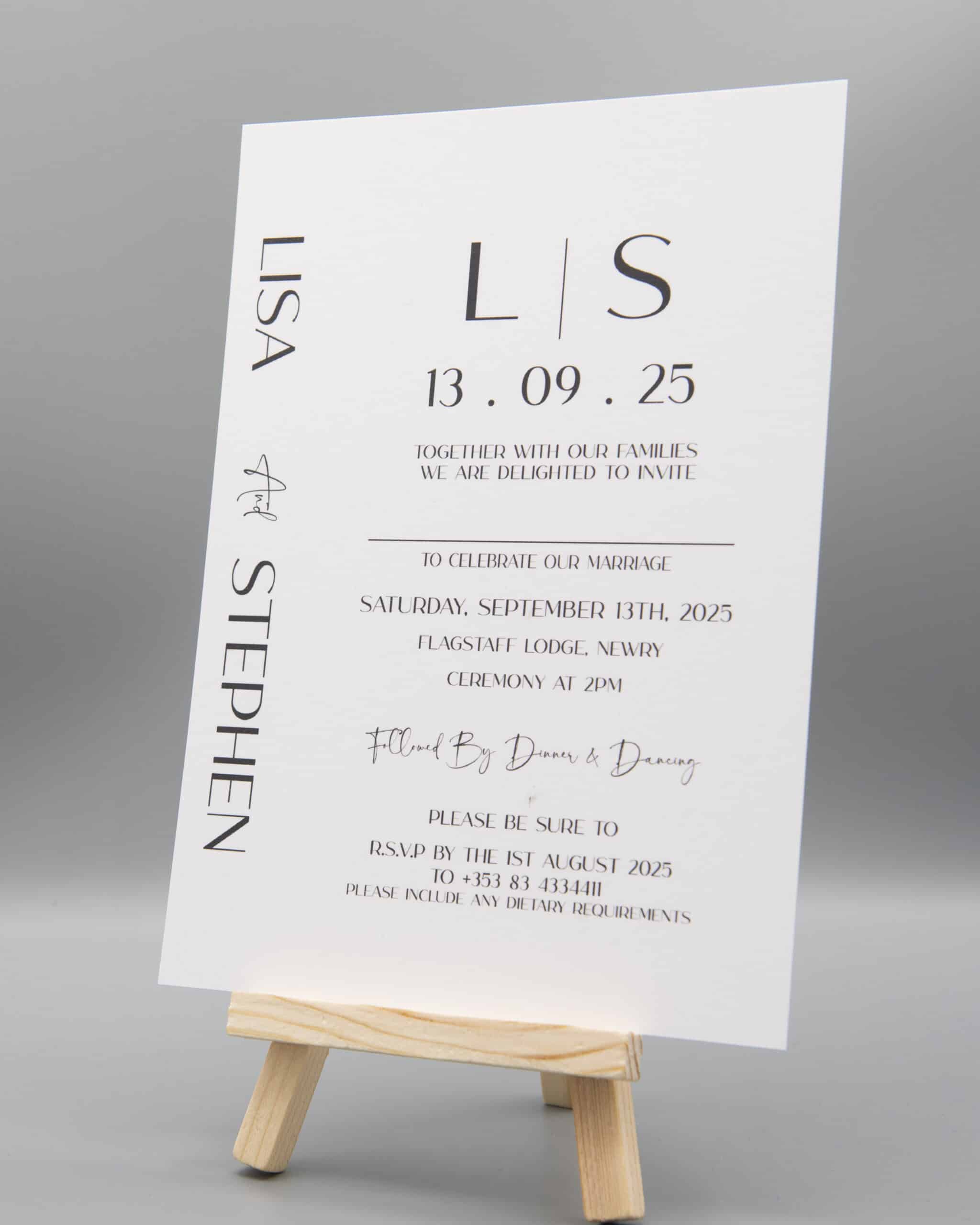 Wedding invitation on easel for Lisa and Stephen, dated September 13, 2025, featuring RSVP details and event location.