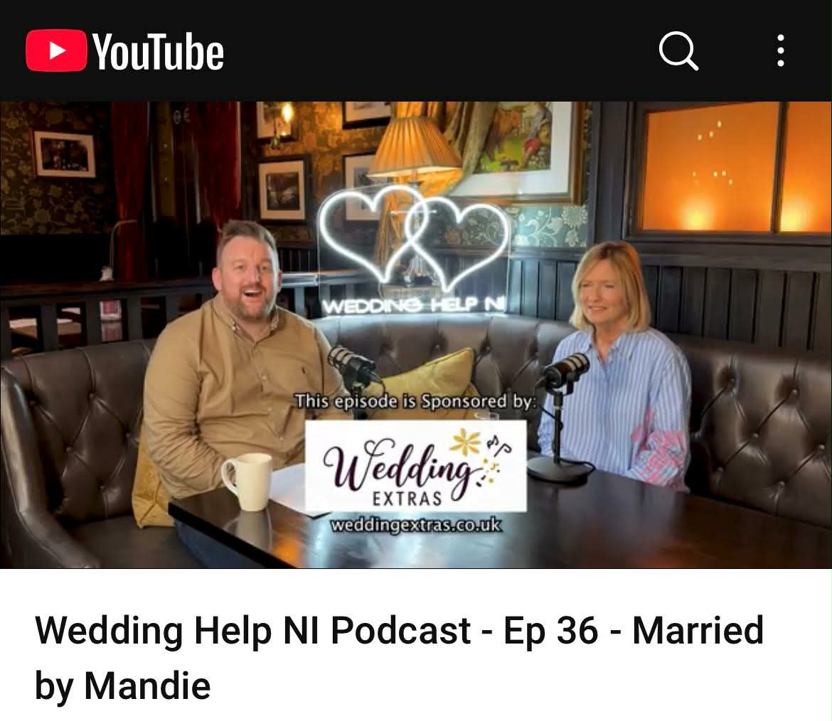 Two people recording a podcast episode titled "Wedding Help NI Podcast - Ep 36 - Married by Mandie" in a cozy setting.